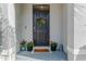 Modern front door with wreath and potted plants at 2922 Suncoast Blend Dr, Odessa, FL 33556