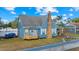 Blue home with stone accents, front yard landscaping, and a bay window at 306 E Paris St, Tampa, FL 33604