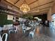 Spacious restaurant interior with white tables, green accents, and a chandelier at 306 E Paris St, Tampa, FL 33604