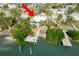 Top-down view of the property, its pool, surrounding trees, and the adjacent canal at 307 10Th Ave, Indian Rocks Beach, FL 33785
