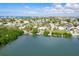 Aerial view of a waterfront home with a private dock and lush landscaping at 307 10Th Ave, Indian Rocks Beach, FL 33785