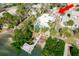 An aerial view captures the home nestled between foliage, with a pool and a nearby waterway at 307 10Th Ave, Indian Rocks Beach, FL 33785