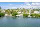 Waterfront property with a dock, tropical foliage, and proximity to other homes at 307 10Th Ave, Indian Rocks Beach, FL 33785