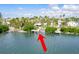 Elevated perspective showcasing the home's private dock and surrounding greenery at 307 10Th Ave, Indian Rocks Beach, FL 33785