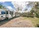 Front exterior view of a home with an RV parked on a paved driveway and landscaping at 307 10Th Ave, Indian Rocks Beach, FL 33785