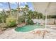 Kidney-shaped pool with a small waterfall feature and a white fence at 307 10Th Ave, Indian Rocks Beach, FL 33785