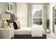 Bedroom featuring a gray upholstered bed, white nightstands, and patterned curtains at 32143 Spiceberry St, San Antonio, FL 33576