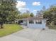 Quaint single-story home with driveway and surrounding trees at 3318 W Ellicott St, Tampa, FL 33614