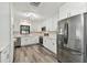 Modern kitchen featuring white shaker cabinets, stainless steel appliances, and sleek countertops at 3318 W Ellicott St, Tampa, FL 33614