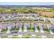 Aerial view of a community with houses, ponds, and lush greenery at 33510 Elm Hill Branch, Wesley Chapel, FL 33545
