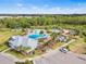 Community pool and amenities featuring lounge area, playground, and lush greenery at 33510 Elm Hill Branch, Wesley Chapel, FL 33545
