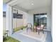 Cozy covered patio with wicker chairs and small table at 33510 Elm Hill Branch, Wesley Chapel, FL 33545