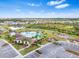 Community pool with clubhouse and playground, surrounded by lush landscaping at 33510 Elm Hill Branch, Wesley Chapel, FL 33545