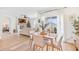 Bright dining area with wood table and chairs, near living room and kitchen at 33510 Elm Hill Branch, Wesley Chapel, FL 33545