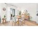 Light and airy dining area with wood table and chairs near sliding glass doors at 33510 Elm Hill Branch, Wesley Chapel, FL 33545