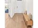 Entryway with light wood flooring and a modern bench for seating at 33510 Elm Hill Branch, Wesley Chapel, FL 33545