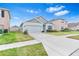 Single story home with light gray siding and a two car garage at 33510 Elm Hill Branch, Wesley Chapel, FL 33545