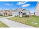 House exterior with gray siding, attached garage, and landscaping at 33510 Elm Hill Branch, Wesley Chapel, FL 33545