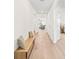 Bright hallway with light wood flooring, leading to living areas and bedrooms at 33510 Elm Hill Branch, Wesley Chapel, FL 33545