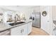 Kitchen with stainless steel refrigerator, granite countertops, island with sink, and modern faucet at 33510 Elm Hill Branch, Wesley Chapel, FL 33545
