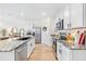 Spacious kitchen featuring granite countertops, stainless steel appliances, and white cabinets at 33510 Elm Hill Branch, Wesley Chapel, FL 33545