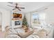 Spacious living room with sectional sofa, fireplace and large window at 33510 Elm Hill Branch, Wesley Chapel, FL 33545