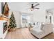 Living room featuring a cozy sectional sofa, fireplace, and large TV at 33510 Elm Hill Branch, Wesley Chapel, FL 33545