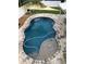 Inviting pool with a tanning shelf, surrounded by travertine pavers at 363 39Th Ave, St Pete Beach, FL 33706