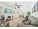 Living room with fireplace, ceiling fan, and dining area at 3709 N Darwin Ave, Tampa, FL 33603