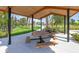 Covered picnic area with wooden tables and benches in a park-like setting at 3718 Capital Reserve Dr, Plant City, FL 33565