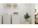 Laundry room with washer, dryer, shelving, and a potted plant at 3759 Capital Reserve Dr, Plant City, FL 33565