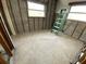Empty bedroom with a ladder, window, and unfinished walls at 415 86Th Ave, St Pete Beach, FL 33706