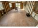 Empty living room with tiled floor, exposed framing, windows, and door at 415 86Th Ave, St Pete Beach, FL 33706