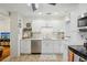 Updated kitchen featuring white shaker cabinets, stainless steel appliances, and decorative backsplash at 429 Rotary Ne Pl, St Petersburg, FL 33703