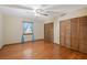 Bedroom with hardwood floors, ceiling fan, and ample closet space at 4823 Miley Rd, Plant City, FL 33565