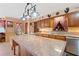 Kitchen island with granite countertop, wooden cabinets, and sink at 4823 Miley Rd, Plant City, FL 33565