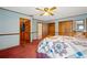 Main bedroom featuring wooden furniture, red carpet, and multiple closets at 4823 Miley Rd, Plant City, FL 33565