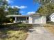 Single-story home with attached garage and driveway at 5136 Skyland Dr, Holiday, FL 34690