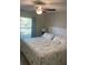 Main bedroom with ceiling fan, large bed, and windows with natural light at 5440 Paula St, North Port, FL 34286