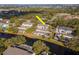 Townhome community aerial view, highlighting a property near a pool and canal at 6289 93Rd N Ter # 4302, Pinellas Park, FL 33782