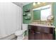 Stylish bathroom with green walls and granite vanity at 6289 93Rd N Ter # 4302, Pinellas Park, FL 33782