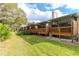 Back exterior of townhouses, showcasing wooden decks and lush landscaping at 6289 93Rd N Ter # 4302, Pinellas Park, FL 33782
