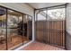 Screened porch with wooden deck and view of the surrounding neighborhood at 6289 93Rd N Ter # 4302, Pinellas Park, FL 33782