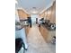 Galley style kitchen with oak cabinets, dark granite counters, black appliances, and tiled floor at 644 Blue Nw Ln, Port Charlotte, FL 33952