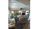 Large living room with two blue couches, a fireplace, several windows, and tile flooring at 644 Blue Nw Ln, Port Charlotte, FL 33952