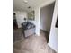 Living room with gray sofa, patterned rug, and access to another room at 644 Blue Nw Ln, Port Charlotte, FL 33952