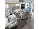 Living room with comfortable seating, ceiling fan, and multiple windows at 644 Blue Nw Ln, Port Charlotte, FL 33952