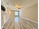 Living room with gray tiled floor, ceiling fan, and staircase at 7218 E Bank Dr # 205, Tampa, FL 33617