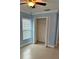 Bedroom with an open closet, ceiling fan, tiled flooring, and light blue walls at 8512 Canterbury Lake Blvd, Tampa, FL 33619