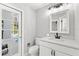 Bathroom with white vanity, toilet, and a view of the pool at 860 Crestridge Cir, Tarpon Springs, FL 34688